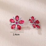 Wholesale ruby red flower earrings with zircon petals on rhodium plated copper and 925 sterling silver pins from JuneJewelry.com – elegant floral jewelry for bulk orders.
