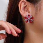 Wholesale ruby red flower earrings with zircon petals on rhodium plated copper and 925 sterling silver pins from JuneJewelry.com – elegant floral jewelry for bulk orders.