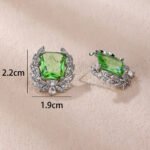 Wholesale zircon leaf earrings with a central red stone and a leaf motif with white cubic zirconia, platinum plated on a copper base with a 925 silver needle, from JuneJewelry.com.