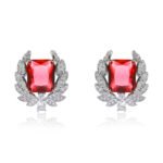 Wholesale zircon leaf earrings with a central red stone and a leaf motif with white cubic zirconia, platinum plated on a copper base with a 925 silver needle, from JuneJewelry.com.