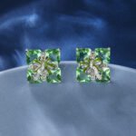 Wholesale green gemstone earrings with a zircon bow on gold plated copper and 925 sterling silver pins from JuneJewelry.com – unique stud earrings for bulk orders.