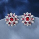 Wholesale Colorful Flower Stud Earrings with a gold plated finish and ruby red cubic zirconia stones from JuneJewelry.com – unique fashion jewelry for bulk orders.