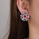 Wholesale Colorful Flower Stud Earrings with a gold plated finish and ruby red cubic zirconia stones from JuneJewelry.com – unique fashion jewelry for bulk orders.