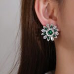 Wholesale Colorful Flower Stud Earrings with a gold plated finish and ruby red cubic zirconia stones from JuneJewelry.com – unique fashion jewelry for bulk orders.