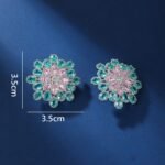 Wholesale Blue Stone Flower Earrings with a gold plated finish and cubic zirconia stones from JuneJewelry.com – unique fashion jewelry for bulk orders.