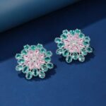 Wholesale Blue Stone Flower Earrings with a gold plated finish and cubic zirconia stones from JuneJewelry.com – unique fashion jewelry for bulk orders.