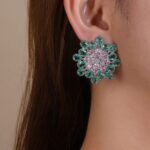 Wholesale Blue Stone Flower Earrings with a gold plated finish and cubic zirconia stones from JuneJewelry.com – unique fashion jewelry for bulk orders.