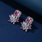 Wholesale pink gemstone earrings with a zircon flower on rhodium plated copper and 925 sterling silver pins from JuneJewelry.com – unique fashion jewelry for bulk orders.