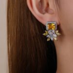 Wholesale pink gemstone earrings with a zircon flower on rhodium plated copper and 925 sterling silver pins from JuneJewelry.com – unique fashion jewelry for bulk orders.