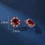 Wholesale ruby red gemstone stud earrings with a zircon cluster on rhodium plated copper and 925 sterling silver pins from JuneJewelry.com – elegant fashion jewelry for bulk orders.