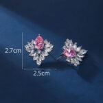 Wholesale Cubic Zirconia Stud Earrings with a central pear-shaped stone and silver plating from JuneJewelry.com – elegant and unique jewelry for bulk orders.