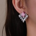 Wholesale Cubic Zirconia Stud Earrings with a central pear-shaped stone and silver plating from JuneJewelry.com – elegant and unique jewelry for bulk orders.