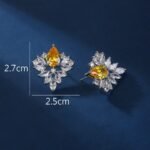 Wholesale Cubic Zirconia Stud Earrings with a central pear-shaped stone and silver plating from JuneJewelry.com – elegant and unique jewelry for bulk orders.