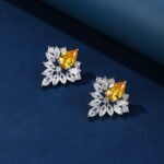 Wholesale Cubic Zirconia Stud Earrings with a central pear-shaped stone and silver plating from JuneJewelry.com – elegant and unique jewelry for bulk orders.