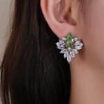 Wholesale Cubic Zirconia Stud Earrings with a central pear-shaped stone and silver plating from JuneJewelry.com – elegant and unique jewelry for bulk orders.