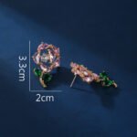 Wholesale Dangle Flower Stud Earrings with a gold plated finish and pink and green cubic zirconia stones from JuneJewelry.com – unique fashion jewelry for bulk orders.