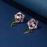 Wholesale Dangle Flower Stud Earrings with a gold plated finish and pink and green cubic zirconia stones from JuneJewelry.com – unique fashion jewelry for bulk orders.