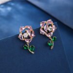 Wholesale Dangle Flower Stud Earrings with a gold plated finish and pink and green cubic zirconia stones from JuneJewelry.com – unique fashion jewelry for bulk orders.
