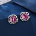 Wholesale pink gemstone stud earrings with a zircon halo on rhodium plated copper and 925 sterling silver pins from JuneJewelry.com – elegant fashion jewelry for bulk orders.