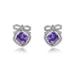 Wholesale pink zircon bow earrings with a central pink stone and cubic zirconia accents, platinum plated on a copper base with a 925 silver needle, from JuneJewelry.com.