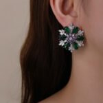 Wholesale Pink Flower Stud Earrings with a gold plated finish and pink and clear cubic zirconia stones from JuneJewelry.com – unique fashion jewelry for bulk orders.
