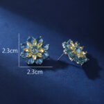 Wholesale Red Flower Stud Earrings with a gold plated finish and ruby red cubic zirconia stones from JuneJewelry.com – unique fashion jewelry for bulk orders.