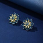 Wholesale Red Flower Stud Earrings with a gold plated finish and ruby red cubic zirconia stones from JuneJewelry.com – unique fashion jewelry for bulk orders.