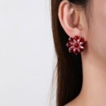 Wholesale Red Flower Stud Earrings with a gold plated finish and ruby red cubic zirconia stones from JuneJewelry.com – unique fashion jewelry for bulk orders.