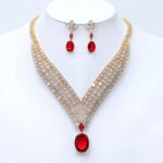 Wholesale platinum plated necklace set with cubic zirconia stones. Elegant brass V-shaped necklace and matching drop earrings for formal wear.