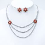 Wholesale bridal zircon jewelry set with multi-layered necklace and floral stud earrings. Platinum-plated copper set for weddings and formal wear from Junejewelry.com.