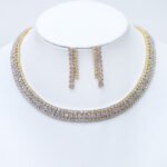Make a dramatic statement with our wholesale triple row collar set, meticulously crafted from high-quality copper and lustrously gold-plated for magnificent sparkle. This original and unique design features a wide, multi-row necklace of dazzling square-cut stones and a pair of elegant, cascading drop earrings with baguette stones, creating a captivating and luxurious aesthetic. Ideal for boutiques, online jewelry stores, and cross-border eCommerce sellers, this set is perfect for customers seeking sophisticated, high-quality accessories. Benefit from our competitive factory-direct pricing and enjoy free worldwide shipping, ensuring exceptional value and profitability for all your bulk purchases at JuneJewelry.com.