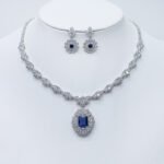 Wholesale floral cushion-cut halo necklace and earring set with platinum plating from JuneJewelry.com – luxurious copper fashion jewelry for bulk orders.