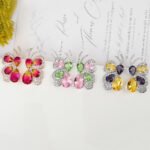 Wholesale butterfly stud earrings with pink and green multi-color zirconia and 925 silver needles from JuneJewelry.com.
