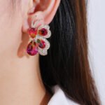 Wholesale butterfly stud earrings with pink and green multi-color zirconia and 925 silver needles from JuneJewelry.com.