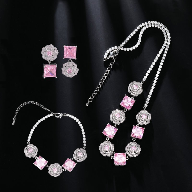 Wholesale Pink Zircon Flower Parure (necklace, bracelet, earrings set) with white-paved flower links and pink square-cut zircon stones, Rhodium plated for a luxury finish.