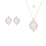 Wholesale Gold Swirl Pearl CZ Set (Necklace & Earrings) displayed on a blue background. The set features a white pearl surrounded by a gold-plated, waterdrop-shaped frame paved with sparkling Cubic Zirconia stones.
