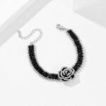 Wholesale Black Camellia Zircon Jewelry Set for women, featuring a black zircon flower choker and a vintage black camellia necklace and bracelet, made from white gold plated copper, emphasizing a high-end, light luxury aesthetic from junejewelry.com.