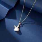 Wholesale Cute Rabbit Pearl Set in two colors: white gold and yellow gold. Both sets feature a white imitation pearl with a micro-pave Cubic Zirconia bunny ear design for the pendant and matching stud earrings.