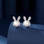 Wholesale Cute Rabbit Pearl Set in two colors: white gold and yellow gold. Both sets feature a white imitation pearl with a micro-pave Cubic Zirconia bunny ear design for the pendant and matching stud earrings.