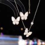 Layered Mother of Pearl Butterfly 2-Piece Set in gold plating. The set includes a pendant necklace and stud earrings, each featuring a dimensional butterfly with MOP wings and a center CZ stone.