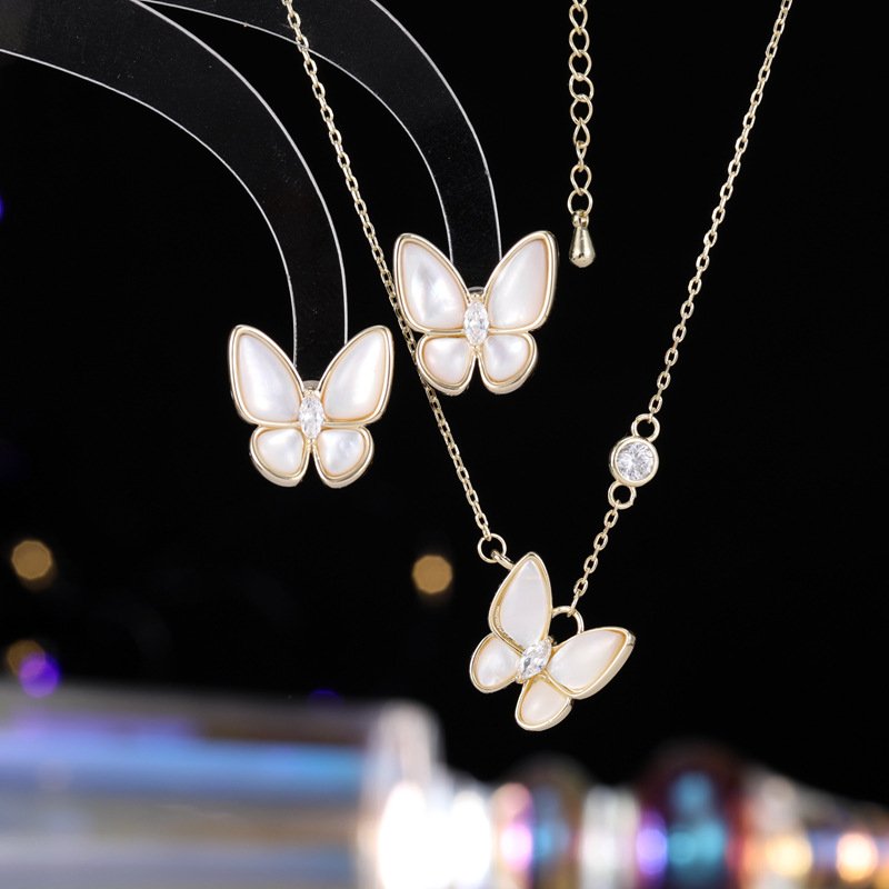 Layered Mother of Pearl Butterfly 2-Piece Set in gold plating. The set includes a pendant necklace and stud earrings, each featuring a dimensional butterfly with MOP wings and a center CZ stone.