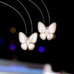 Layered Mother of Pearl Butterfly 2-Piece Set in gold plating. The set includes a pendant necklace and stud earrings, each featuring a dimensional butterfly with MOP wings and a center CZ stone.