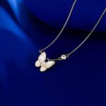 Layered Mother of Pearl Butterfly 2-Piece Set in gold plating. The set includes a pendant necklace and stud earrings, each featuring a dimensional butterfly with MOP wings and a center CZ stone.