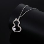 Wholesale Neo-Chinese Gourd Pearl Jewelry Set (Hulu shape), featuring hollowed-out metalwork, elegant pearls, includes matching stud earrings, necklace, and ring, a light luxury advanced sense accessory set from junejewelry.com.