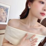 Wholesale Butterfly Shell Jewelry Set shown in gold and silver colors. The elegant set includes a butterfly pendant necklace, stud earrings, and an adjustable ring, all featuring iridescent Mother of Pearl wings and micro-paved Cubic Zirconia accents.