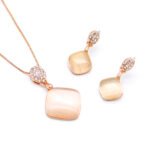 Wholesale rose gold cat eye set with square pendant necklace and drop earrings, accented with clear zircon stones, from JuneJewelry.com.