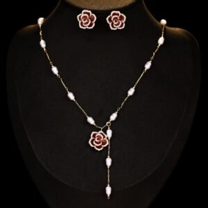 Wholesale Baroque Pearl Camellia Set displayed on a black bust. Features a Y-style necklace with small baroque pearls and a black micro-pave Camellia pendant, matching the Camellia stud earrings.