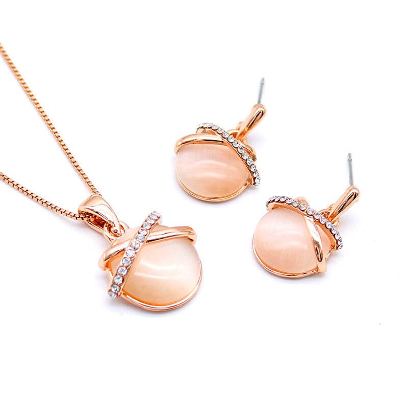 Wholesale Cross Cat Eye Set with round milky stone and a ribbon of cubic zirconia in rose gold plating from JuneJewelry.com – unique fashion jewelry for bulk orders.