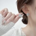 Wholesale Pearl Zircon Half Ball Set showing both the Rose Gold Plated version (Champagne Pearl) and the Silver Plated version (Gray Pearl) on black display mannequins.