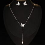 Mother of Pearl Butterfly Lariat Necklace Set shown in both gold and silver finishes. The set includes a Y-necklace with an MOP butterfly and pearl drop, and matching MOP butterfly stud earrings.